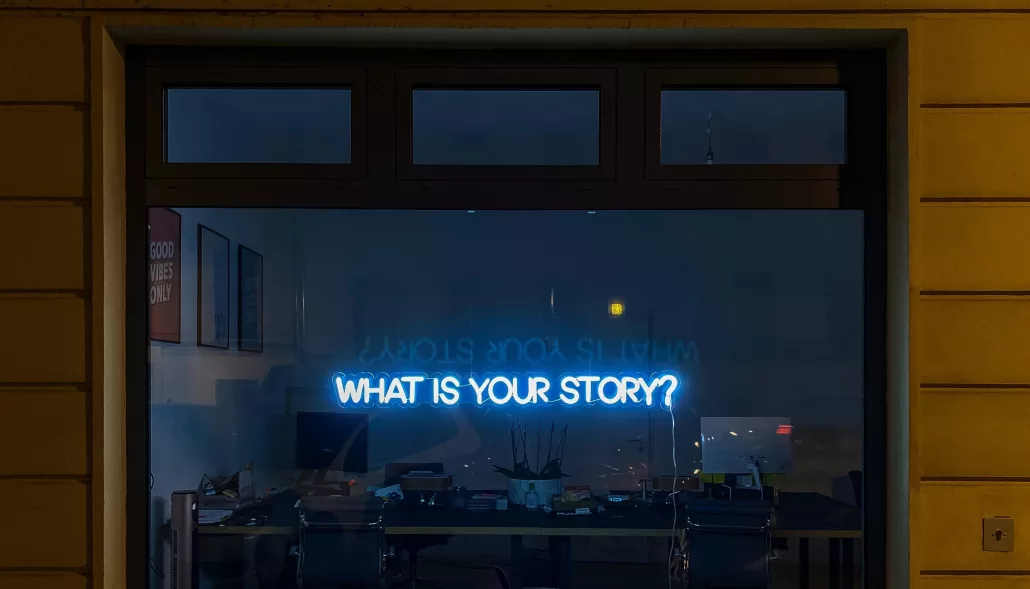 A neon sign that says what is your story?.