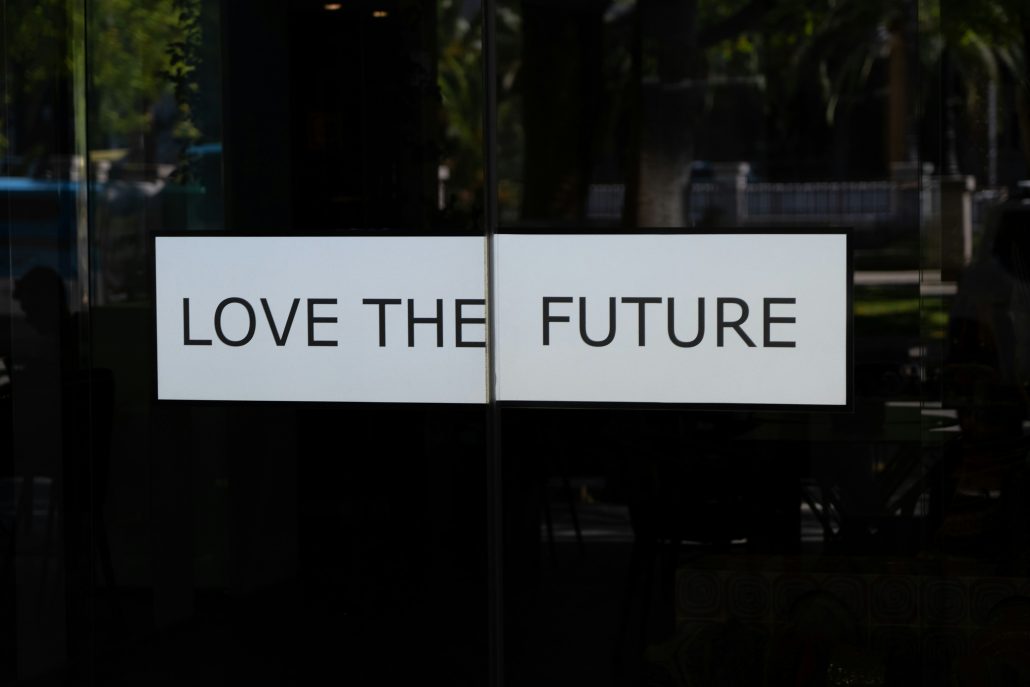 Sign on glass doors with the phrase "love the future" split between the two panels, perfect for a mid-career resume.